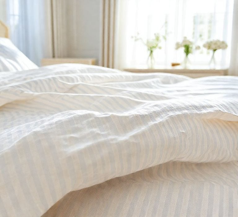 The Benefits of Seersucker Bedding: Your Ultimate Guide 2 A close up photograph of luxurious seersucker bedding - perfectextile