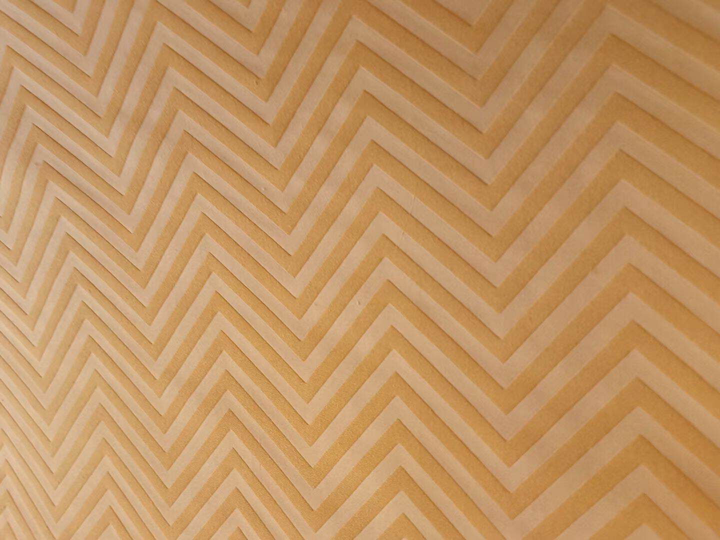 Embossed microfiber fabric chevron pattern in gold