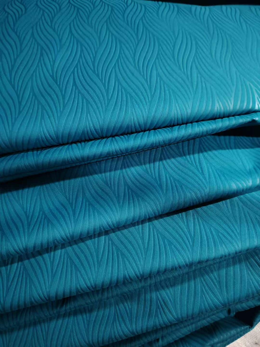 Embossed microfiber fabric flame wave pattern in teal