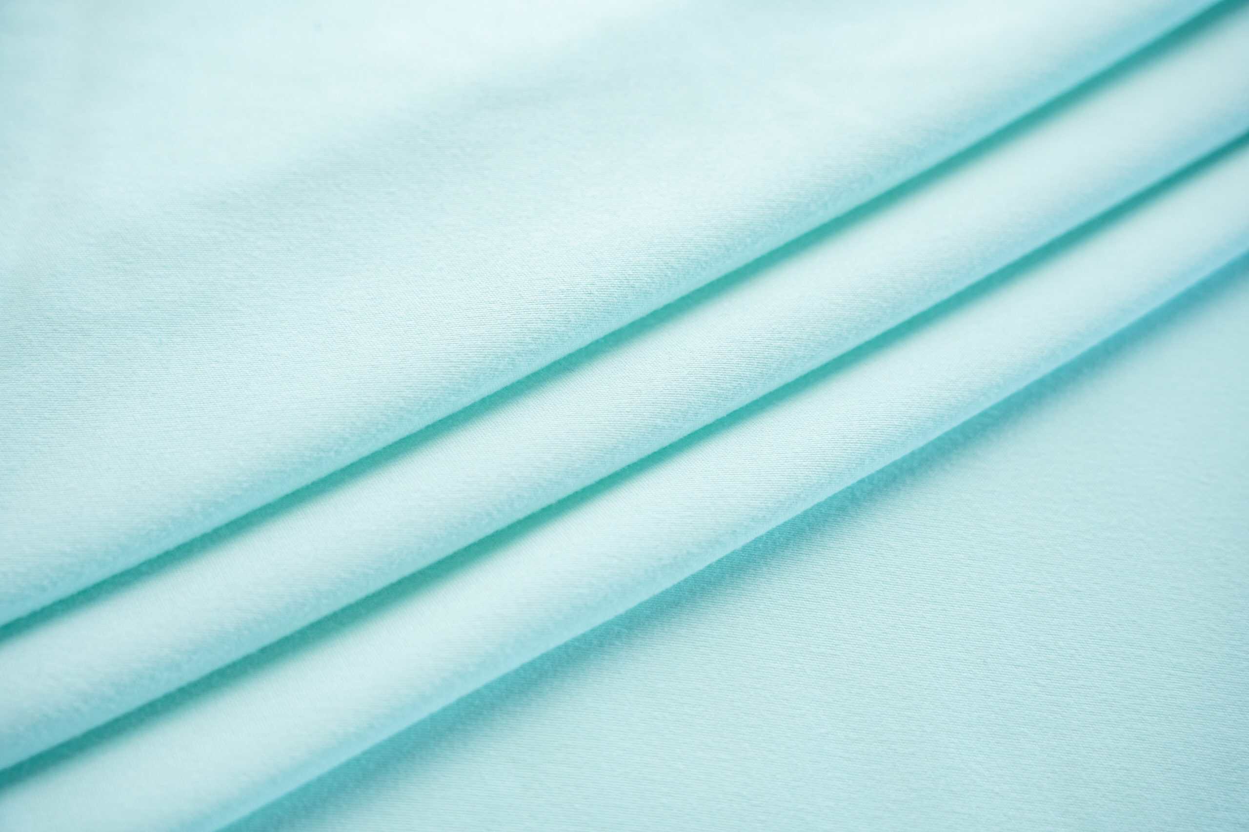 Solid color dyed microfiber fabric surface texture close-up